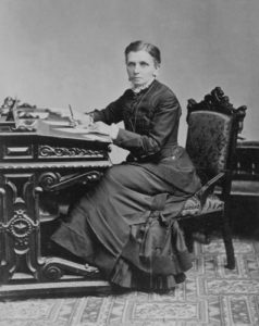 Emmeline B. Wells sitting at writing desk