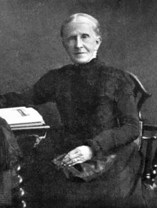 Photograph of older woman, seated.