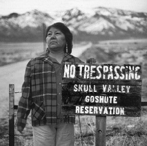 Margene Bullcreek stands with a no trespassing sign on the Skull Valley reservation.